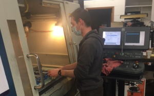 Apprentice using CNC Machine