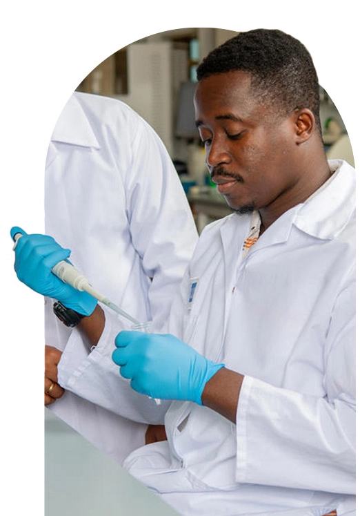 black male scientist is analyzing a liquid to extract molecules in the test tubes in laboratory.